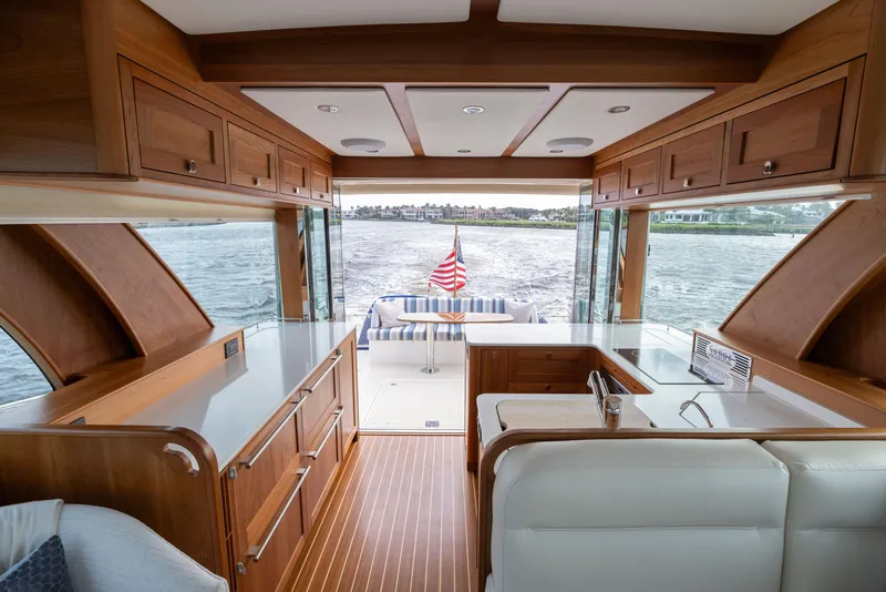 Slide: The Image of Interior of 2026 Sabre 58 Salon Express yacht with elegant wood finish and water view. - 8