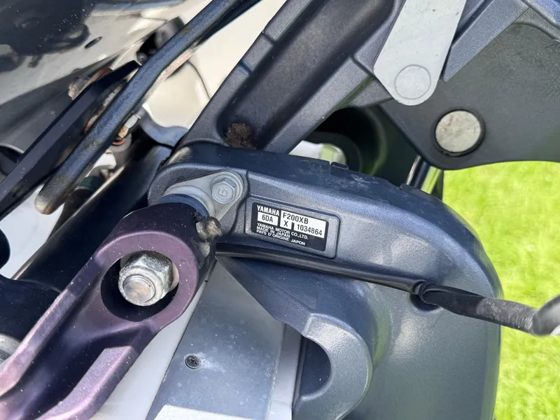 Slide: The Image of Close-up of a Yamaha F200XB engine part on a 2018 NauticStar DC 243 Sport Deck. - 14