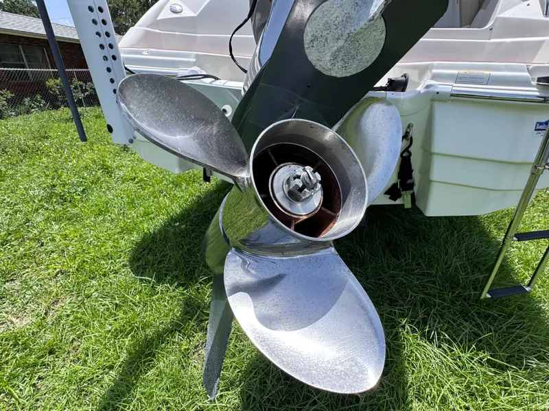 Slide: The Image of Propeller of 2018 NauticStar DC 243 Sport Deck boat on grass. - 15