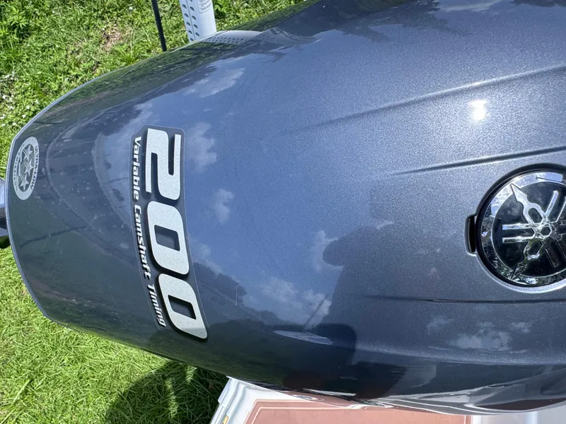 Slide: The Image of Outboard motor of 2018 NauticStar DC 243 Sport Deck on grass. - 16