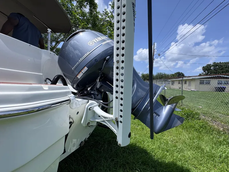 Slide: The Image of 2018 NauticStar DC 243 Sport Deck with Yamaha outboard motor, parked on grass. - 17