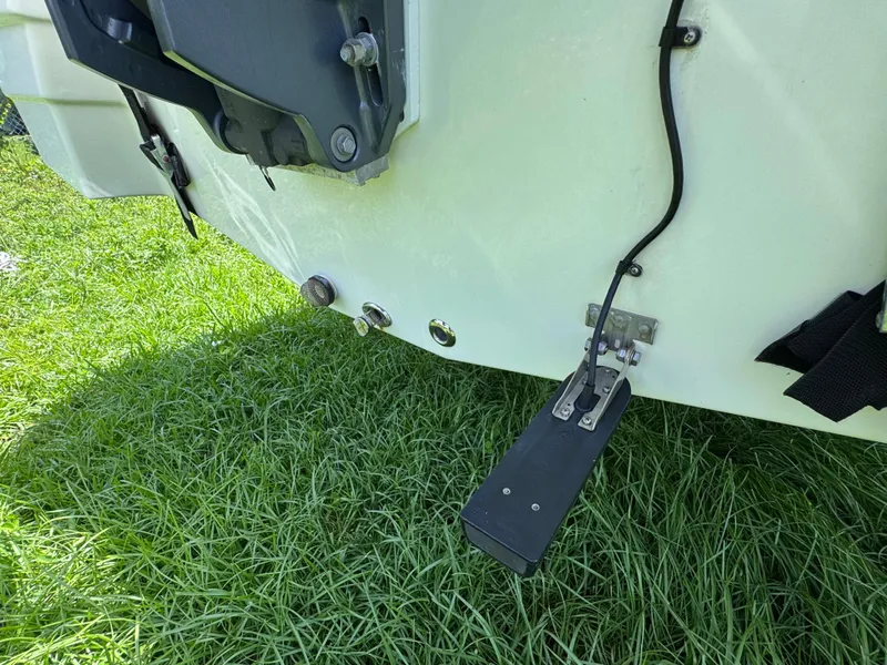 Slide: The Image of 2018 NauticStar DC 243 Sport Deck boat transom with trim tab on grass. - 18