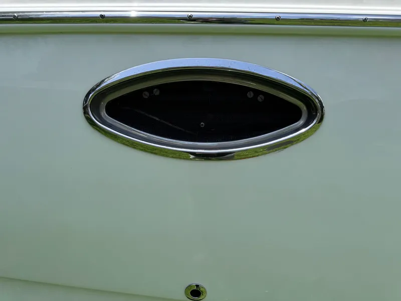 Slide: The Image of 2018 NauticStar DC 243 Sport Deck boat detail with chrome oval vent. - 21