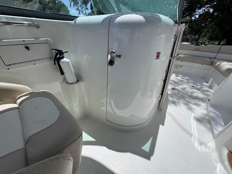 Slide: The Image of 2018 NauticStar DC 243 Sport Deck interior with seating and storage compartments. - 32