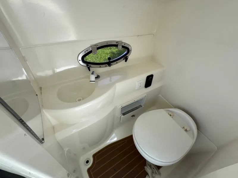 Slide: The Image of 2018 NauticStar DC 243 Sport Deck boat bathroom with sink and toilet. - 35
