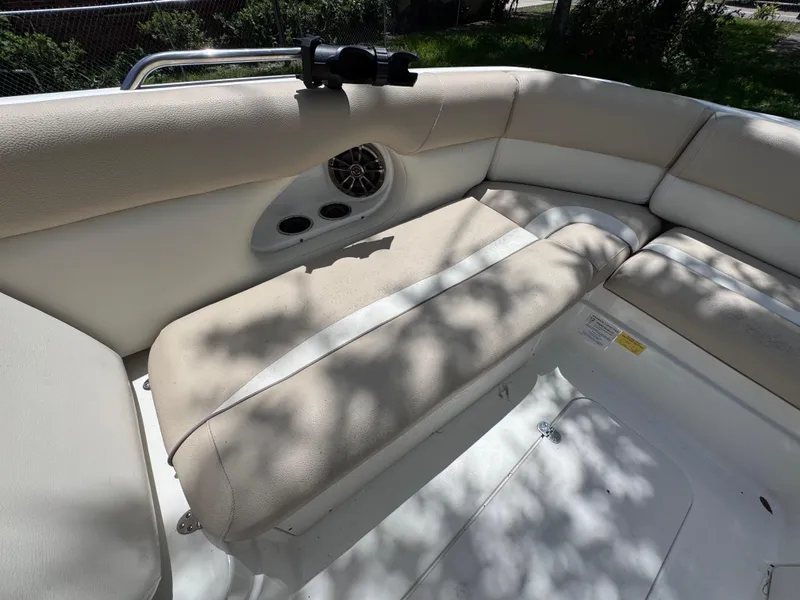 Slide: The Image of 2018 NauticStar DC 243 Sport Deck boat interior with cushioned seating and speaker system. - 37