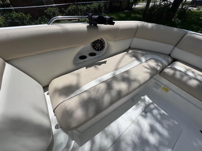 Slide: The Image of 2018 NauticStar DC 243 Sport Deck interior with beige seating and speaker system. - 38