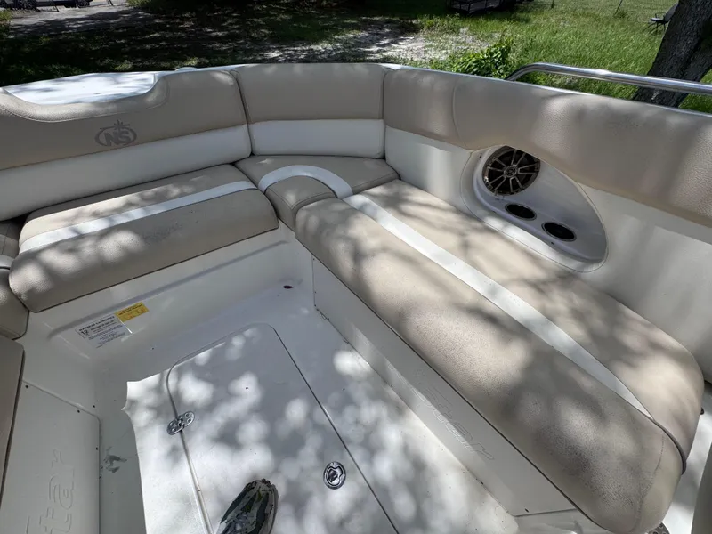 Slide: The Image of 2018 NauticStar DC 243 Sport Deck interior with beige seating and speaker. - 39