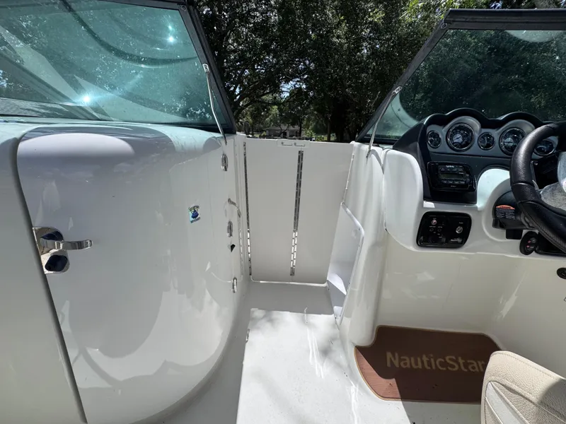 Slide: The Image of 2018 NauticStar DC 243 Sport Deck interior with steering wheel and dashboard controls. - 40