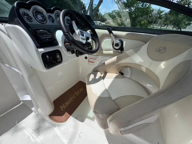 Slide: The Image of 2018 NauticStar DC 243 Sport Deck interior with steering wheel and dashboard. - 41