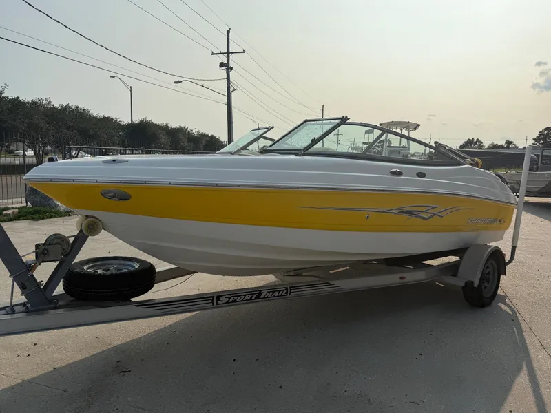 Slide: The Image of 2008 Chaparral SSi 190 boat with yellow and white design on a trailer. - 11