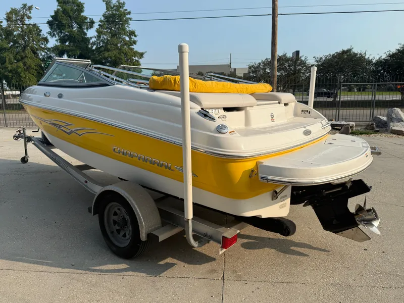Slide: The Image of 2008 Chaparral SSi 190 boat on trailer, yellow and white design, parked outdoors. - 12