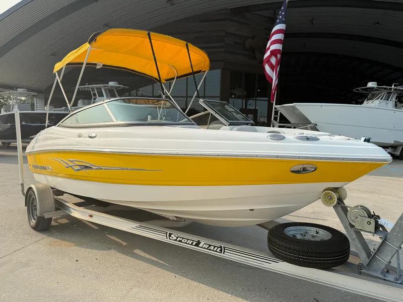 Slide: The Image of 2008 Chaparral SSi 190 boat with yellow accents on a trailer, parked outdoors. - 2