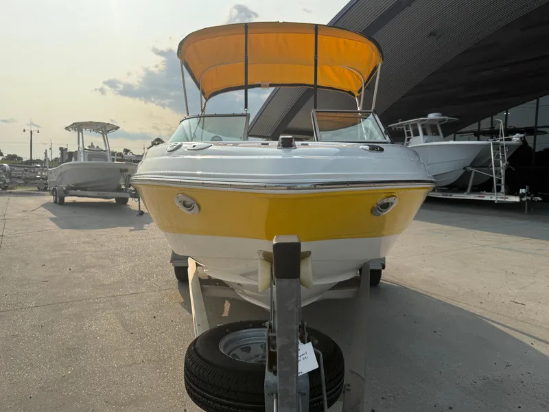 Slide: The Image of 2008 Chaparral SSi 190 boat with yellow hull and canopy, parked on a trailer. - 3