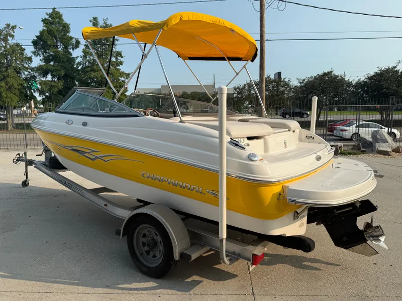 Slide: The Image of 2008 Chaparral SSi 190 boat with yellow accents and canopy on a trailer. - 5