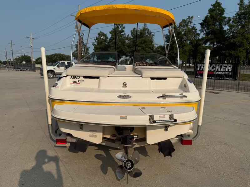 Slide: The Image of 2008 Chaparral SSi 190 boat with yellow canopy, rear view in parking lot. - 6