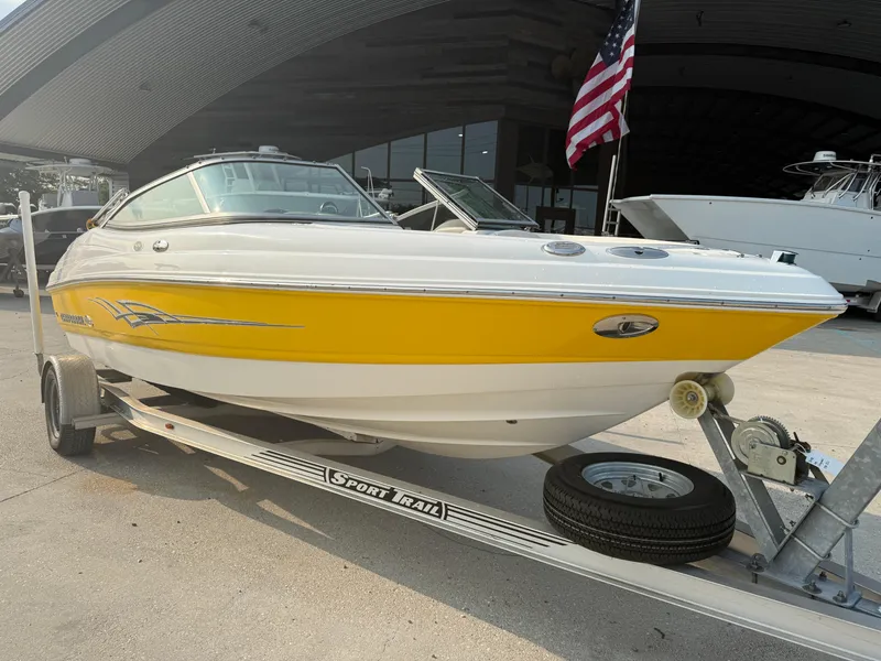 Slide: The Image of 2008 Chaparral SSi 190 boat with yellow and white design on a trailer. - 9