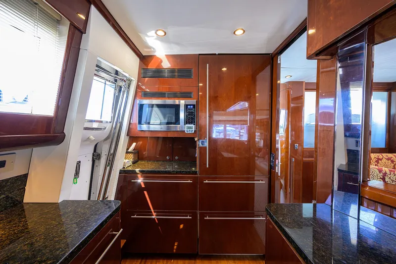 Slide: The Image of Luxurious 2006 Viking Princess Sport Cruisers yacht kitchen with modern appliances and wood cabinetry. - 20