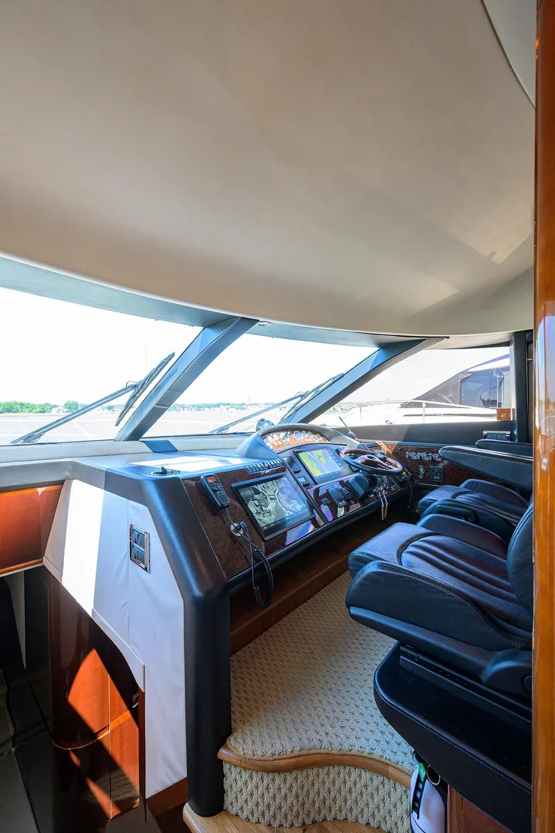 Slide: The Image of Interior of 2006 Viking Princess Sport Cruisers yacht, featuring a modern helm and luxurious seating. - 21