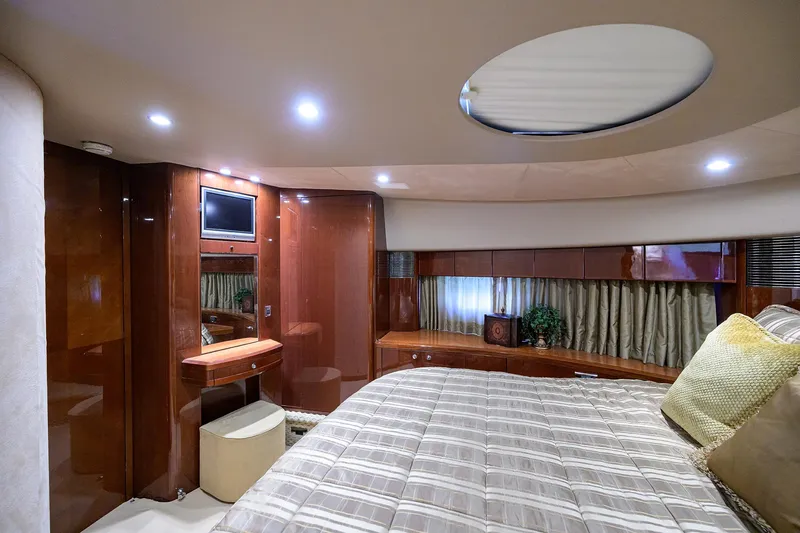 Slide: The Image of Luxurious 2006 Viking Princess Sport Cruisers cabin with elegant wood finishes and cozy bedding. - 25