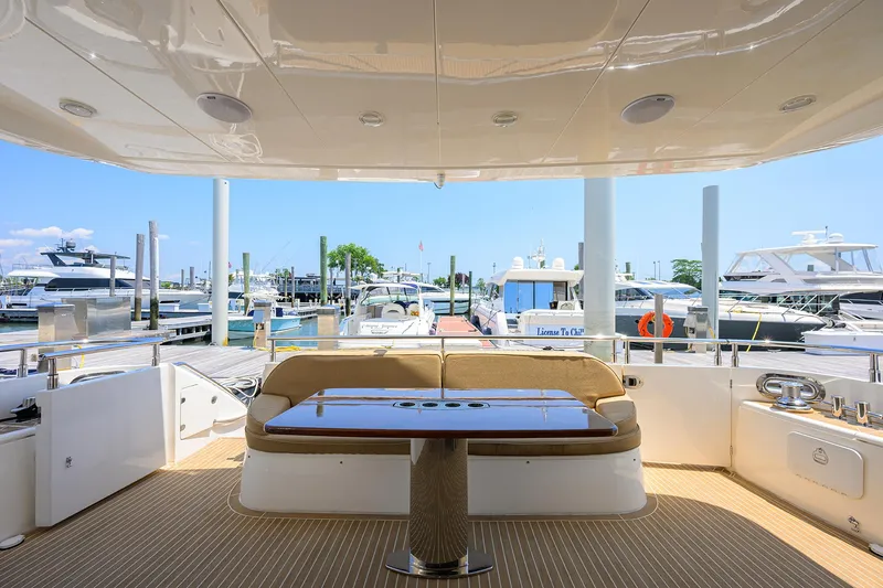 Slide: The Image of Luxury 2006 Viking Princess Sport Cruiser yacht docked at marina, featuring elegant seating and table. - 3