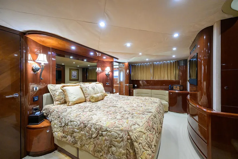 Slide: The Image of Luxurious 2006 Viking Princess Sport Cruisers bedroom with elegant wood finishes and ambient lighting. - 31