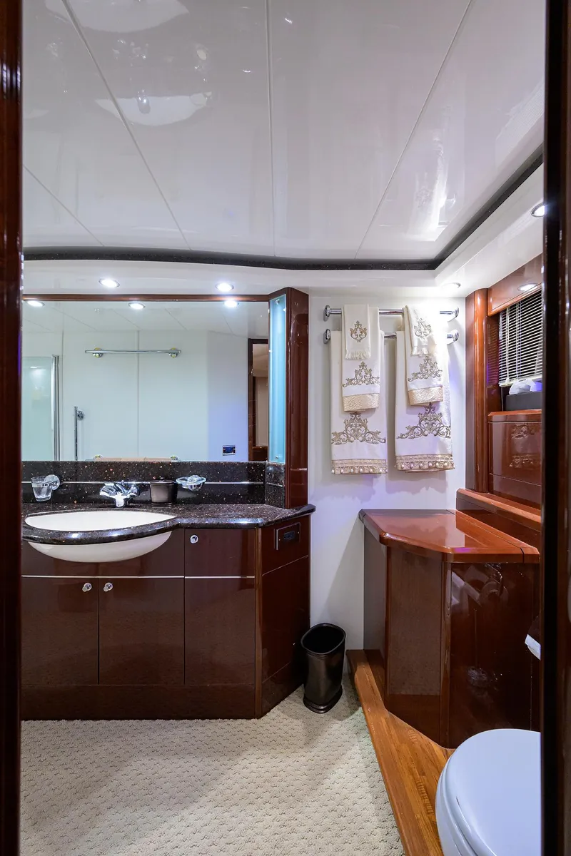 Slide: The Image of Luxurious bathroom in 2006 Viking Princess Sport Cruisers yacht, featuring elegant wood finishes. - 36