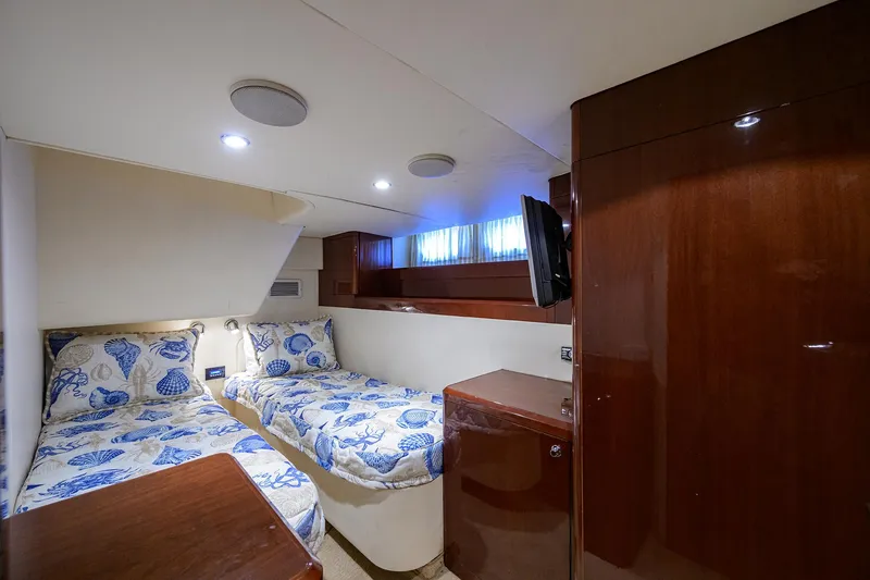 Slide: The Image of 2006 Viking Princess Sport Cruisers cabin with twin beds and elegant wood finish. - 45