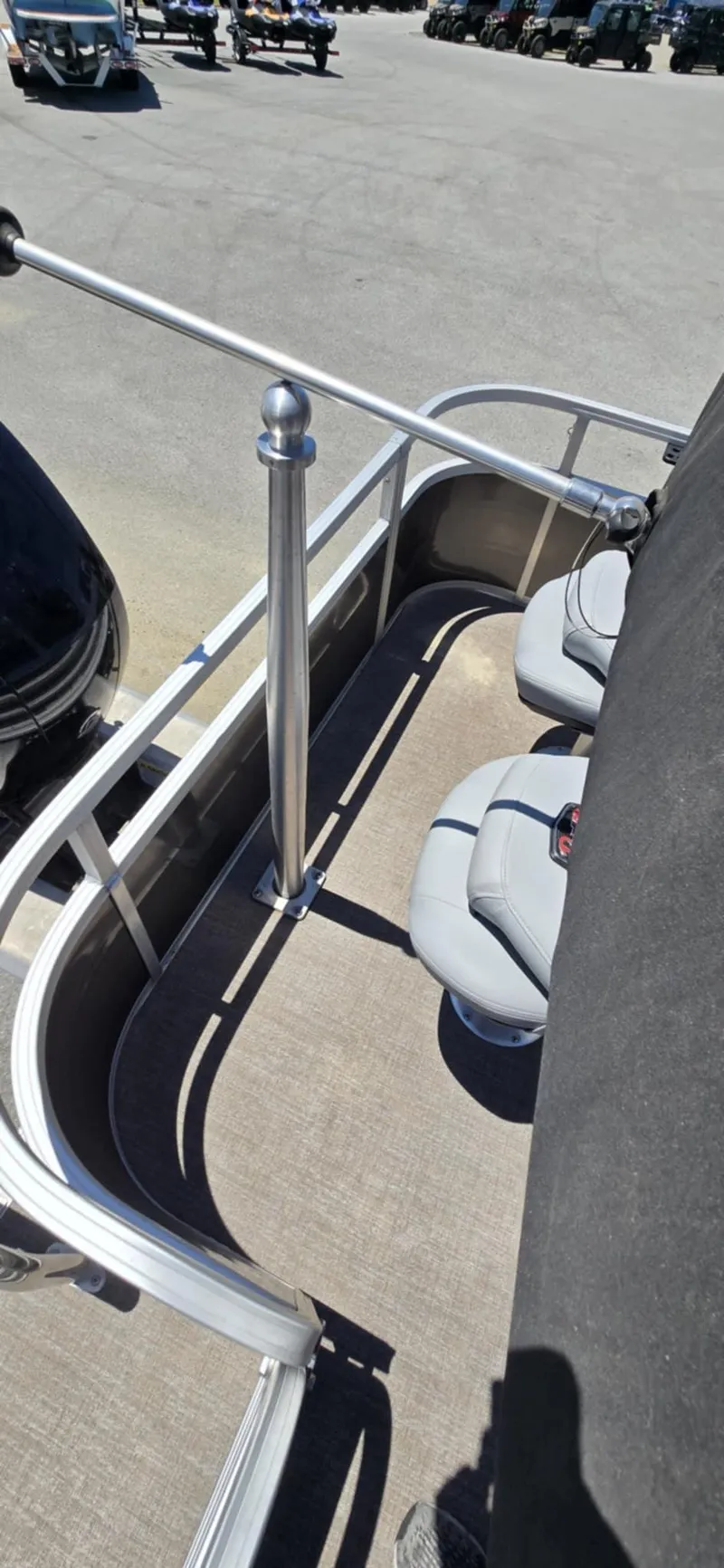 Slide: The Image of 2020 Ranger Reata 220FC boat deck with seating and railing in sunlight. - 12