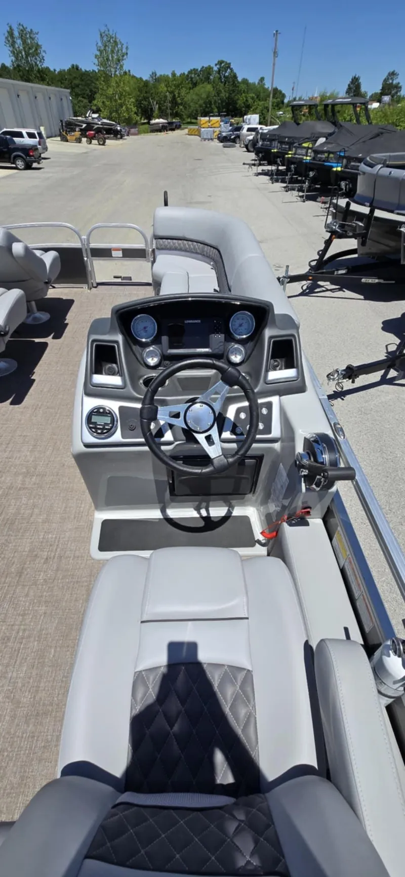 Slide: The Image of 2020 Ranger Reata 220FC boat dashboard with steering wheel and controls. - 15