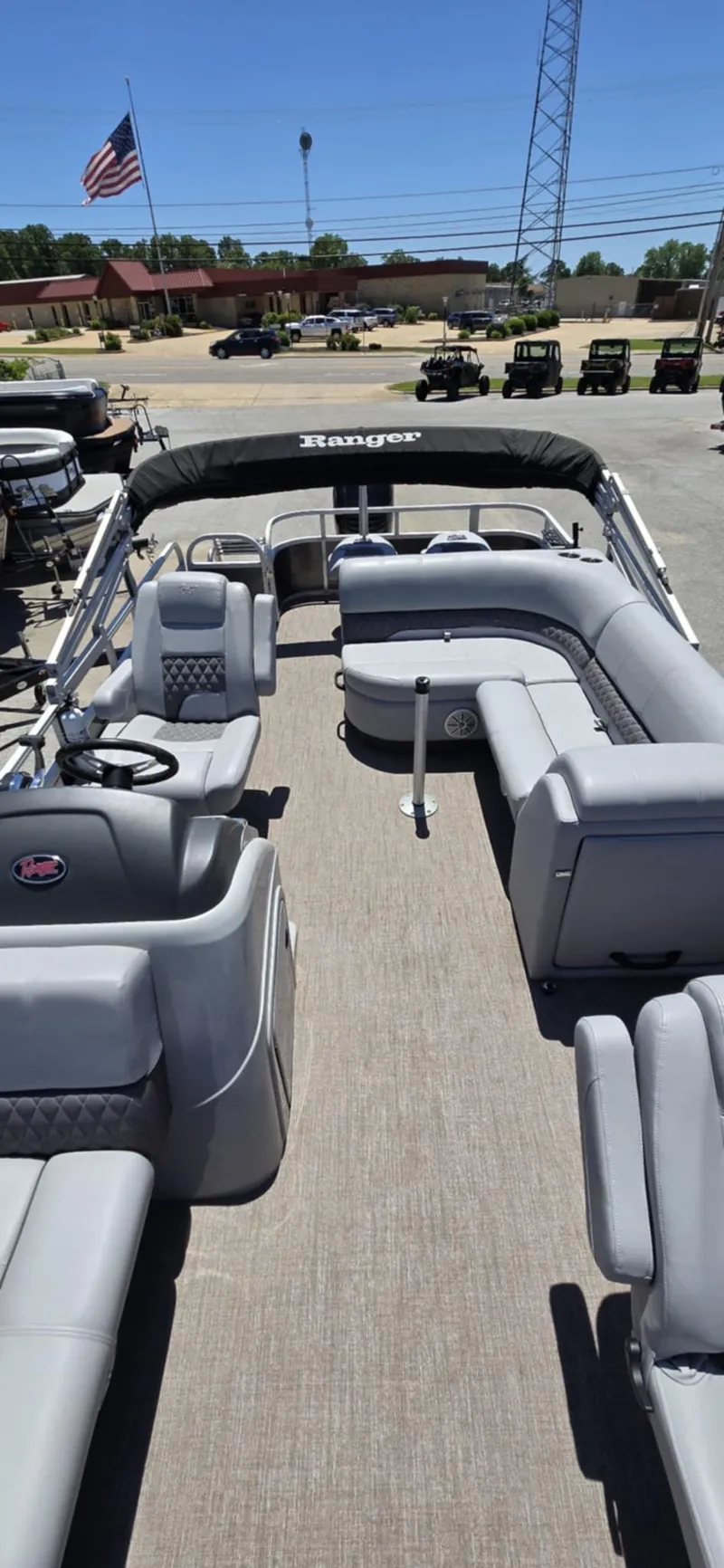 Slide: The Image of 2020 Ranger Reata 220FC pontoon boat with spacious seating and canopy, parked outdoors. - 21