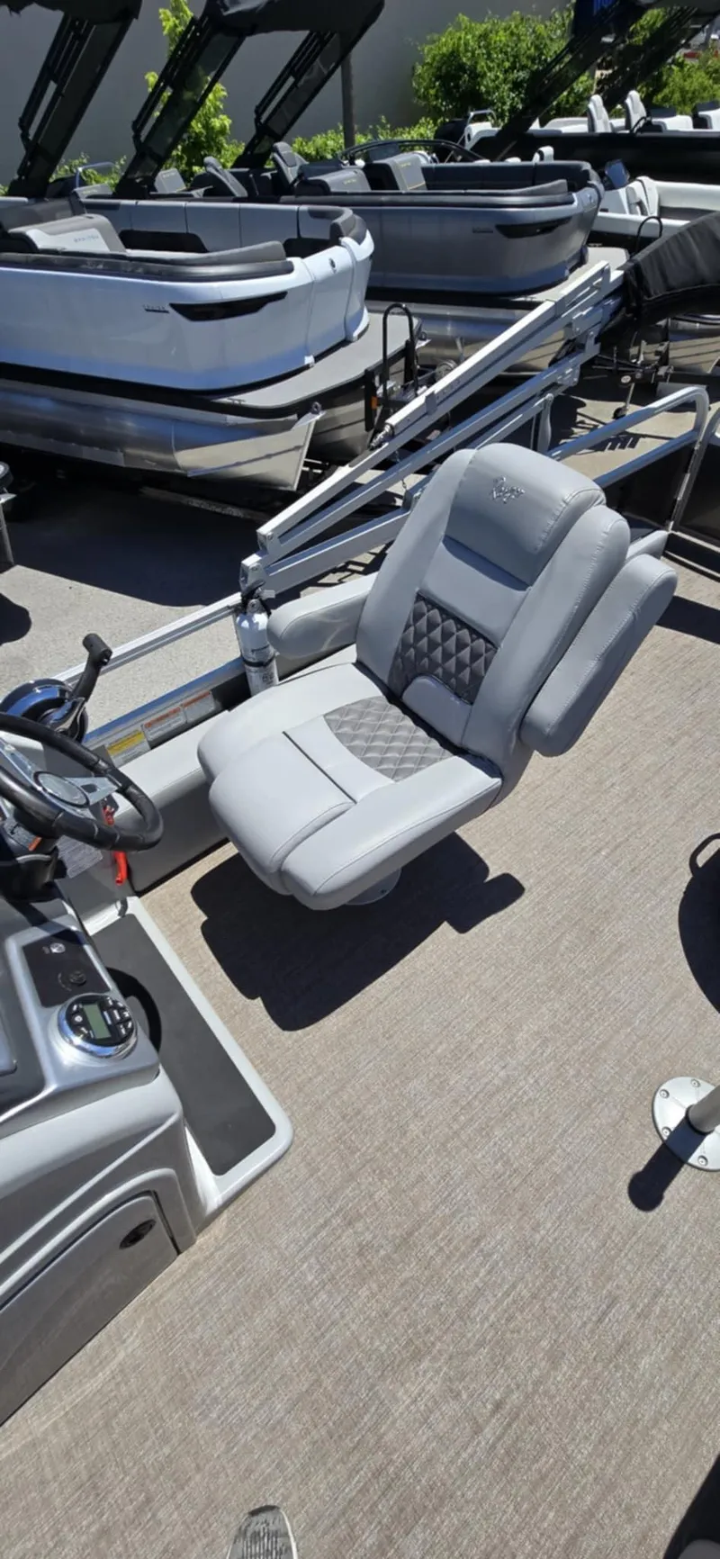 Slide: The Image of 2020 Ranger Reata 220FC boat interior with gray captain's chair and steering console. - 22
