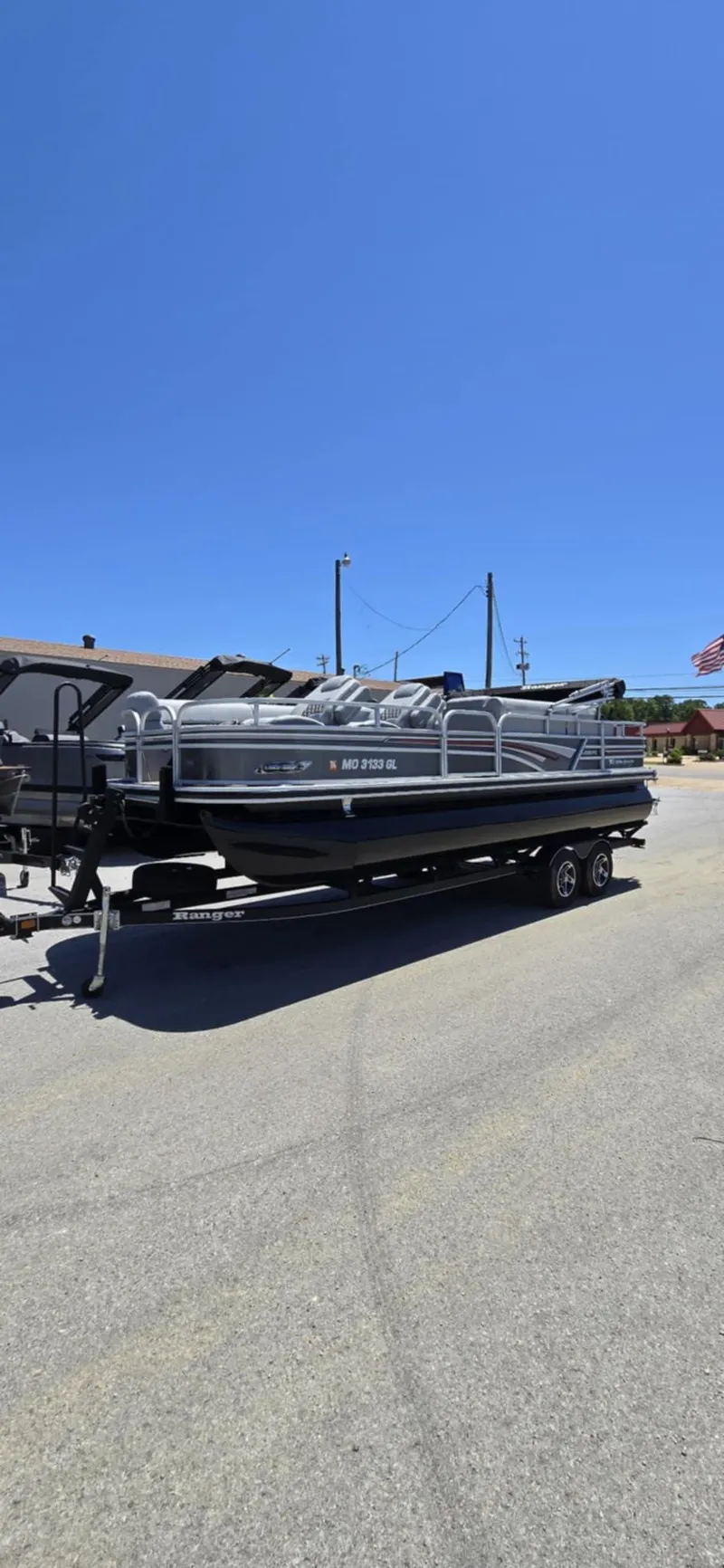 Slide: The Image of 2020 Ranger Reata 220FC pontoon boat on trailer under clear blue sky. - 7