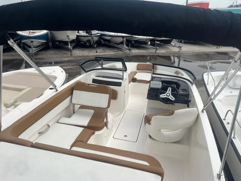 Slide: The Image of 2021 Bayliner VR5 Bowrider OB with tan and white interior, docked at marina. - 10