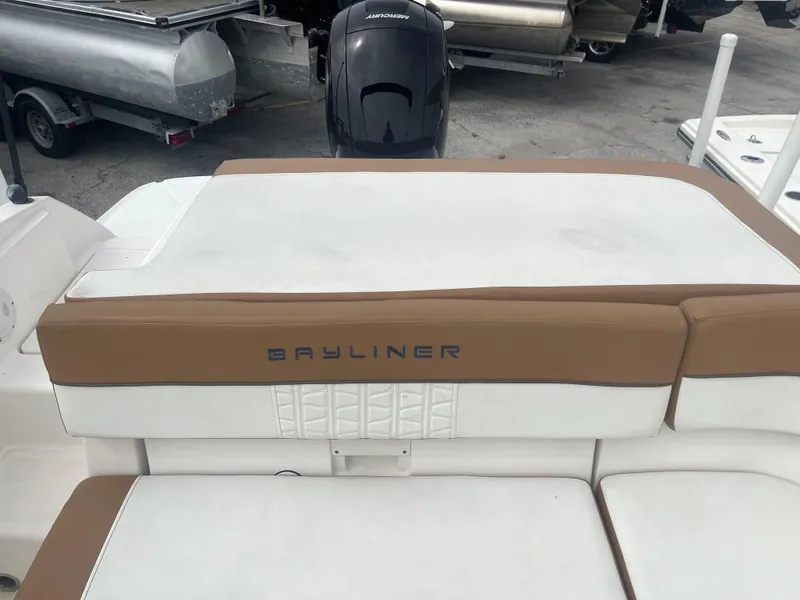 Slide: The Image of 2021 Bayliner VR5 Bowrider OB boat with cushioned seating and outboard motor. - 12