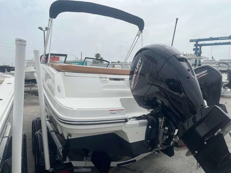 Slide: The Image of 2021 Bayliner VR5 Bowrider OB with Mercury outboard engine, docked on trailer. - 2