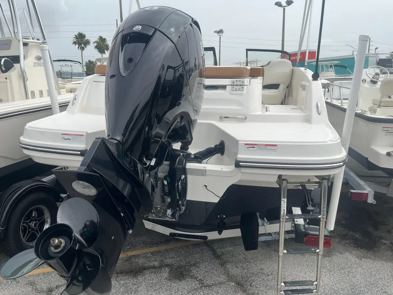 Slide: The Image of 2021 Bayliner VR5 Bowrider OB with outboard motor, docked in a marina. - 4