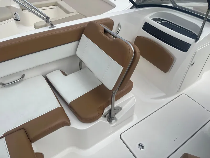 Slide: The Image of 2021 Bayliner VR5 Bowrider OB interior with brown and white seating. - 7