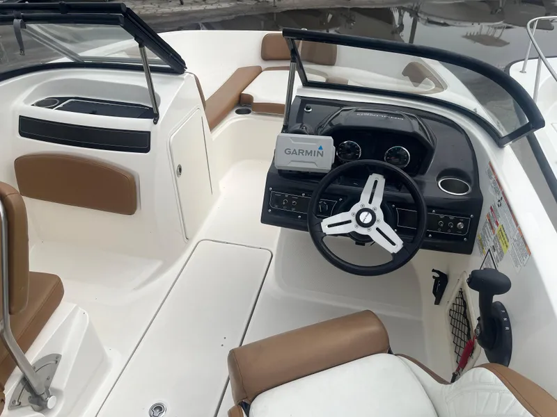 Slide: The Image of 2021 Bayliner VR5 Bowrider OB interior with Garmin navigation, brown and white seating. - 8