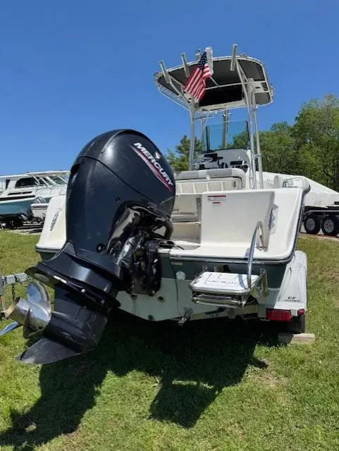 Slide: The Image of 2020 Mako 214 CC boat with Mercury outboard motor, parked on grass. - 3