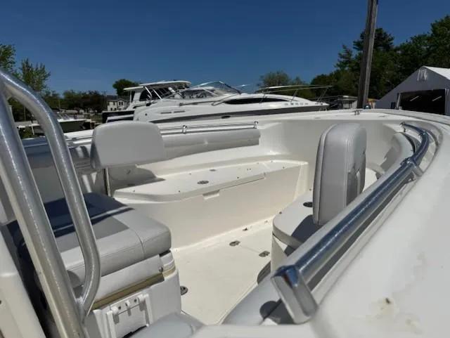 Slide: The Image of 2020 Mako 214 CC boat interior with seating and railings under clear blue sky. - 5