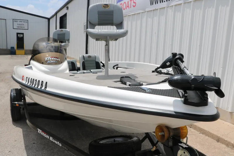 Slide: The Image of 2009 Triton 17 Explorer boat on trailer, parked outside a building. - 10