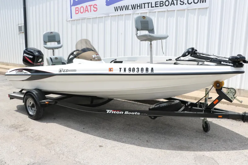 Slide: The Image of 2009 Triton 17 Explorer boat on trailer, displayed outside Whittle Boats dealership. - 12