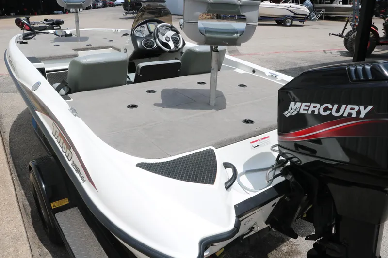 Slide: The Image of 2009 Triton 17 Explorer boat with Mercury engine, featuring spacious deck and seating. - 14