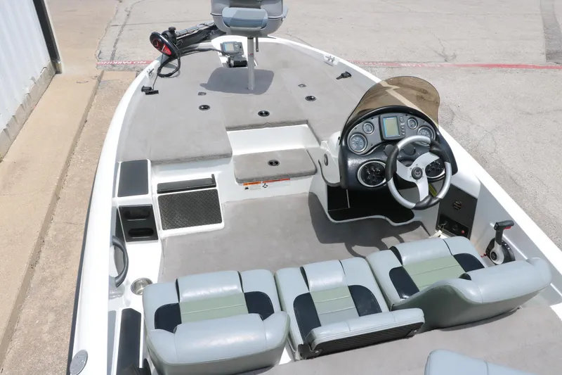 Slide: The Image of 2009 Triton 17 Explorer boat interior with steering wheel and seating. - 15