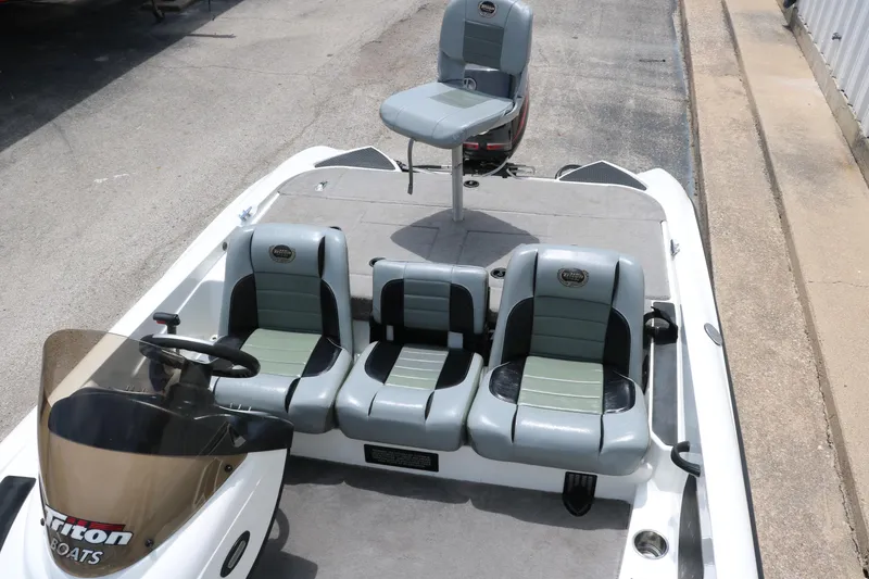 Slide: The Image of 2009 Triton 17 Explorer boat with gray seating and steering console. - 22