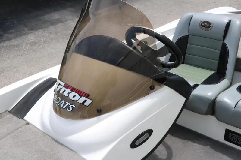 Slide: The Image of 2009 Triton 17 Explorer boat console with steering wheel and windshield. - 23
