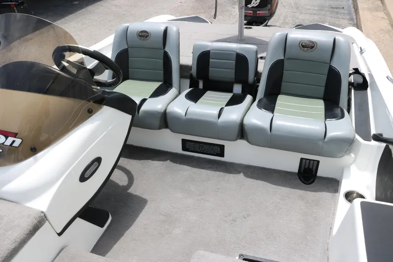 Slide: The Image of 2009 Triton 17 Explorer boat interior with three cushioned seats and steering console. - 24