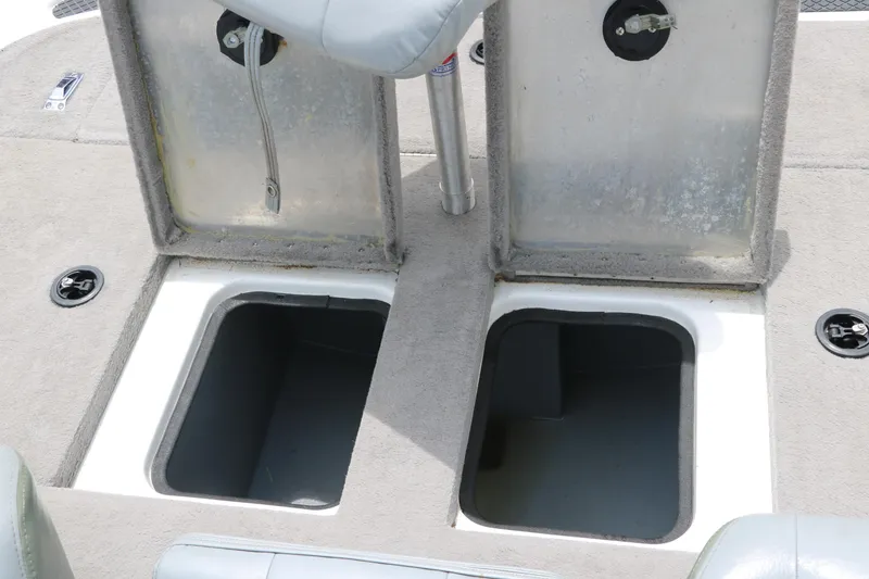 Slide: The Image of 2009 Triton 17 Explorer boat storage compartments with open lids. - 26
