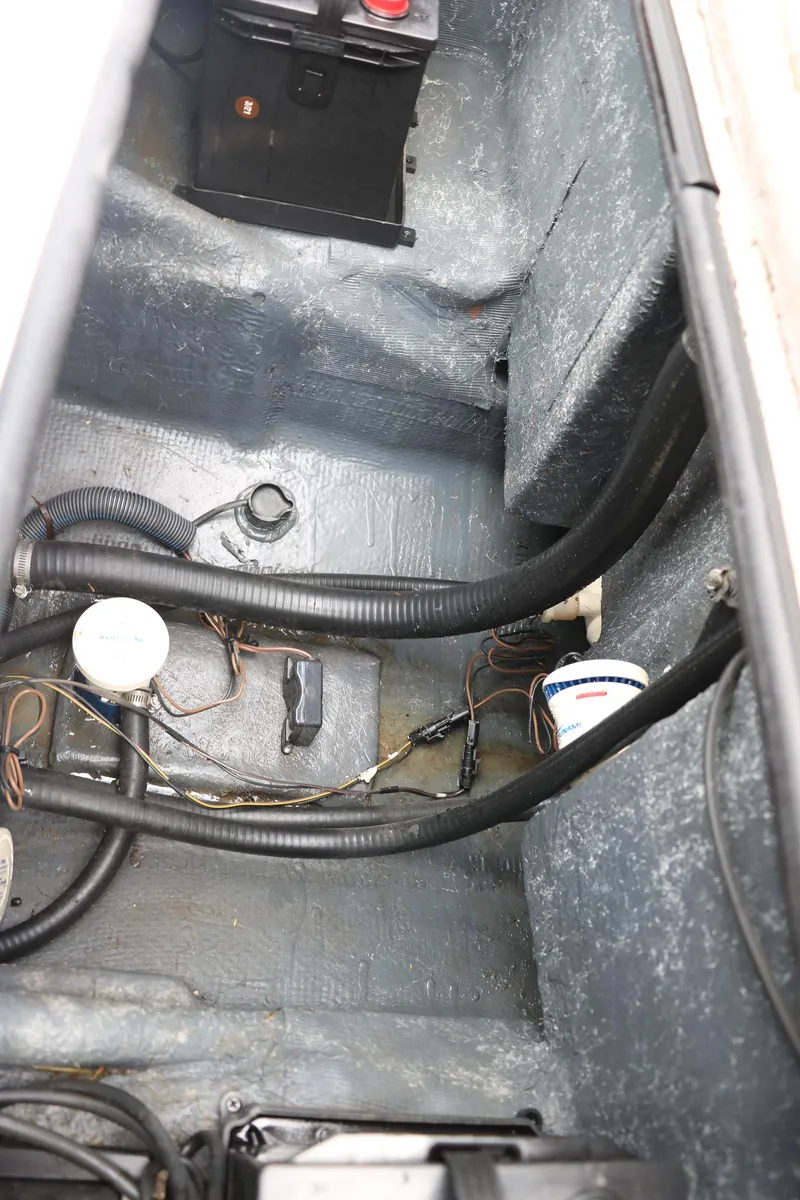 Slide: The Image of 2009 Triton 17 Explorer boat interior showing wiring and battery compartment. - 28